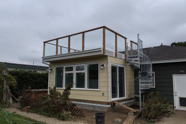 Screen Shot 2026-01-12 at 10.05.29 AM A unique addition with a room with large windows on the first story with a winding staircase going to a deck built on the roof of the addition.