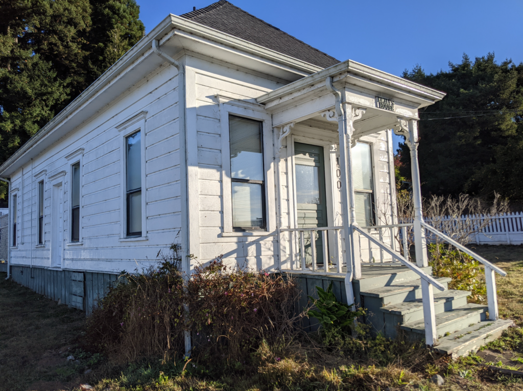Exterior view of the front of the historic Shotgun house, showing the narrow and long footprint of the house.