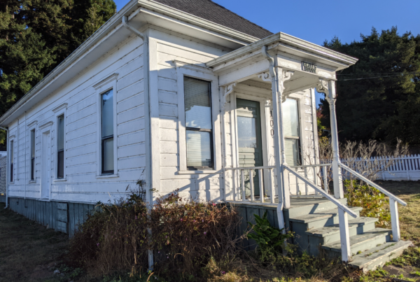 Exterior view of the front of the historic Shotgun house, showing the narrow and long footprint of the house.