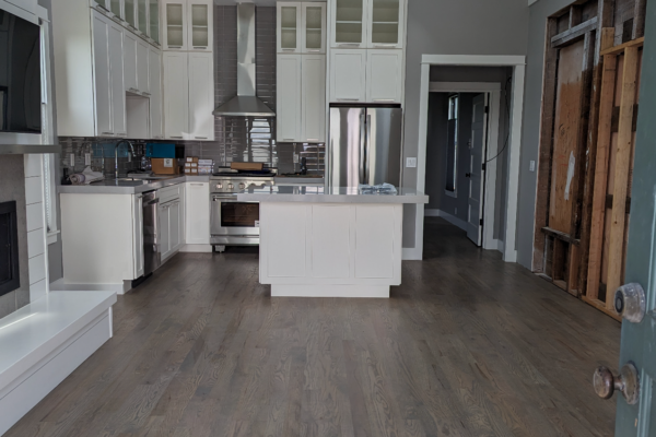 The remodeled kitchen with new appliances and new cabinets in the historic Shotgun house.