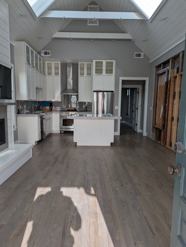 The remodeled kitchen with new appliances and new cabinets in the historic Shotgun house.