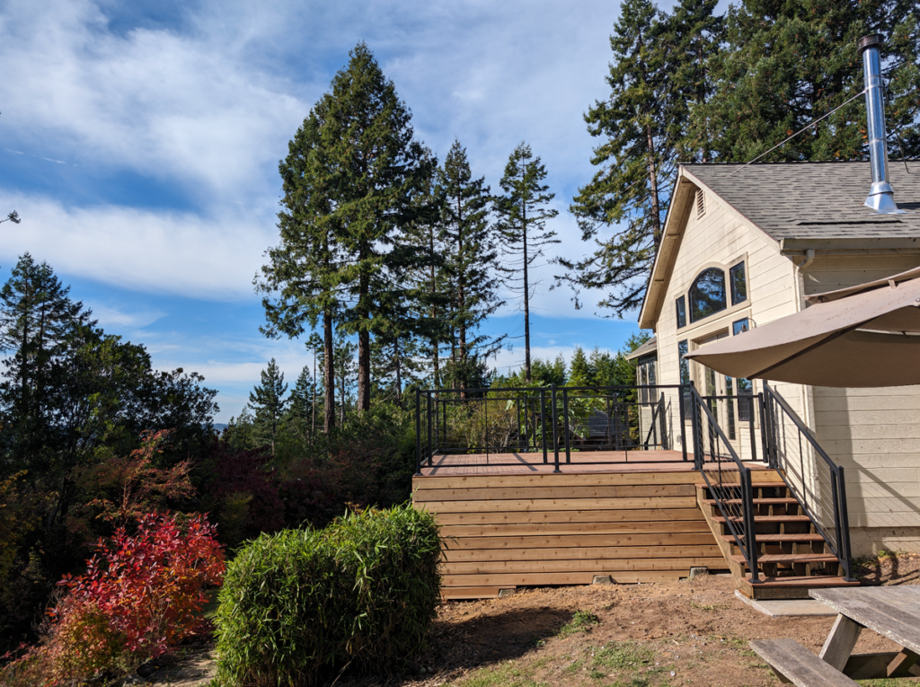 A beautiful, sunny deck built overlooking the hillside as an addition to the client's home.