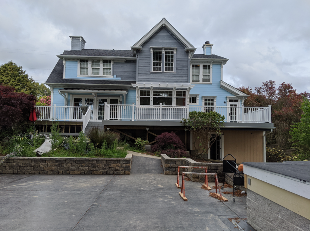 Exterior view of the nearly completed Blue Victorian remodel, only awaiting paint on the siding to match the original blue color.