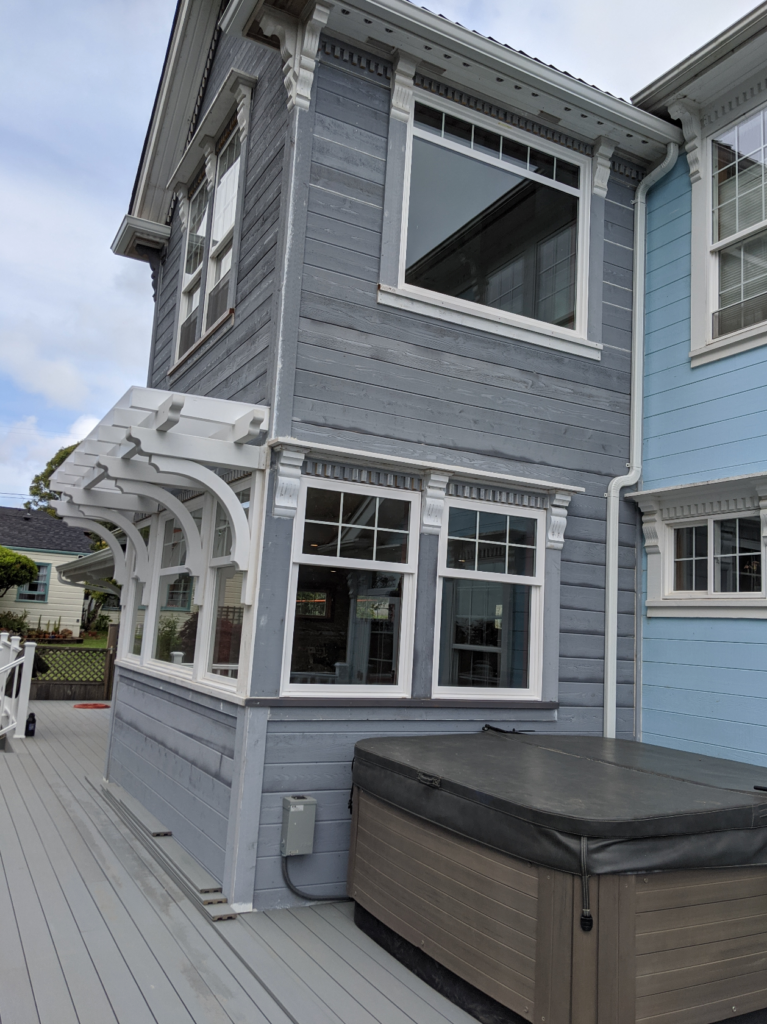 Exterior view of the two story addition created for the Victorian remodel, showcasing the expertly carved wooden awning pieces.