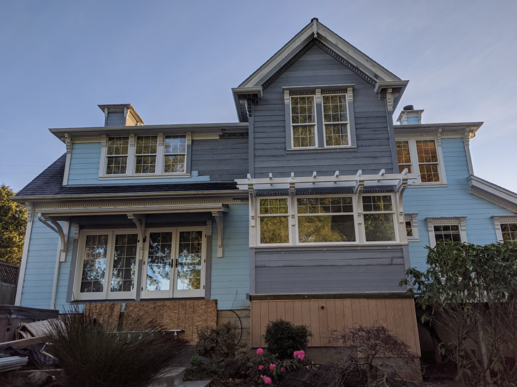 Exterior view of the Victorian Remodel with the new wooden awning and siding added, but not painted yet.