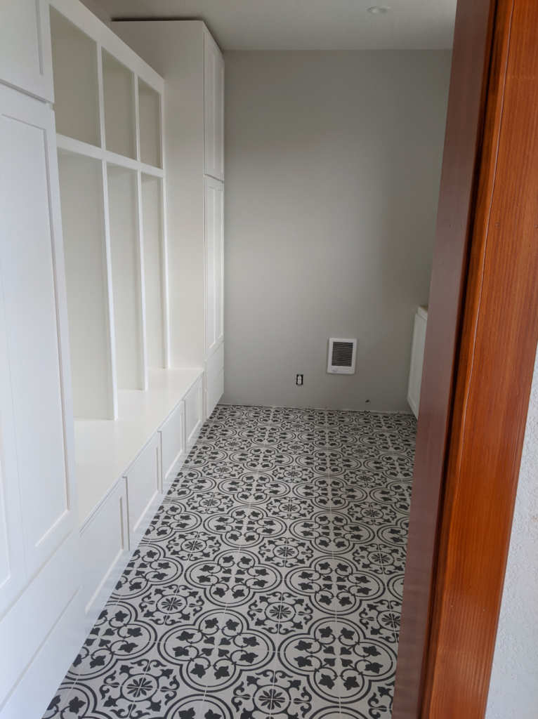 Interior room of the Victorian remodel showing beautiful black and white tile laid with precision.